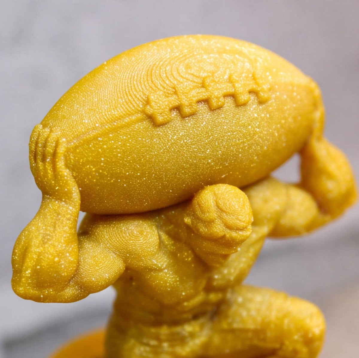 Close-up of the sparkle gold football and Atlas figure