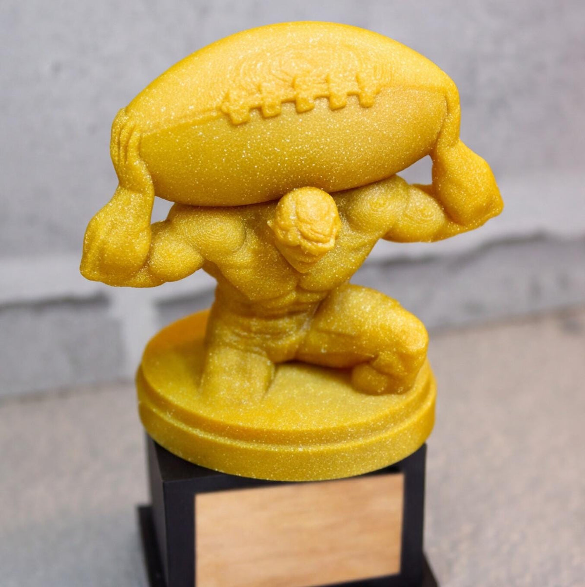 Carried the League figure kneeling on its gold pedestal