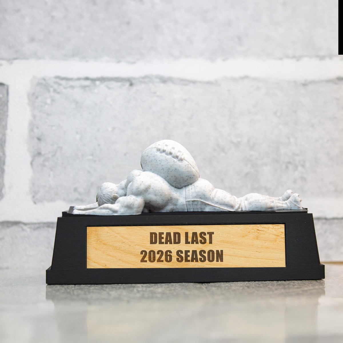 Dead Last trophy with a white marble figure